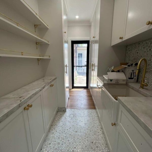 Butler's pantry with open shelving, marble benchtop and brass tapware, Ashbury renovation