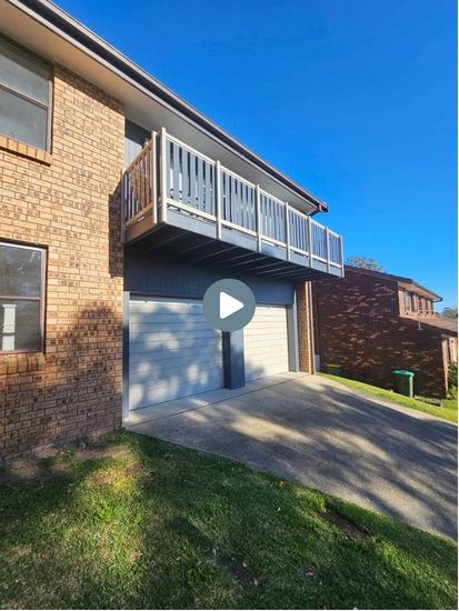 Exterior of the Yarrawarrah second storey addition showing the new upper balcony and garage